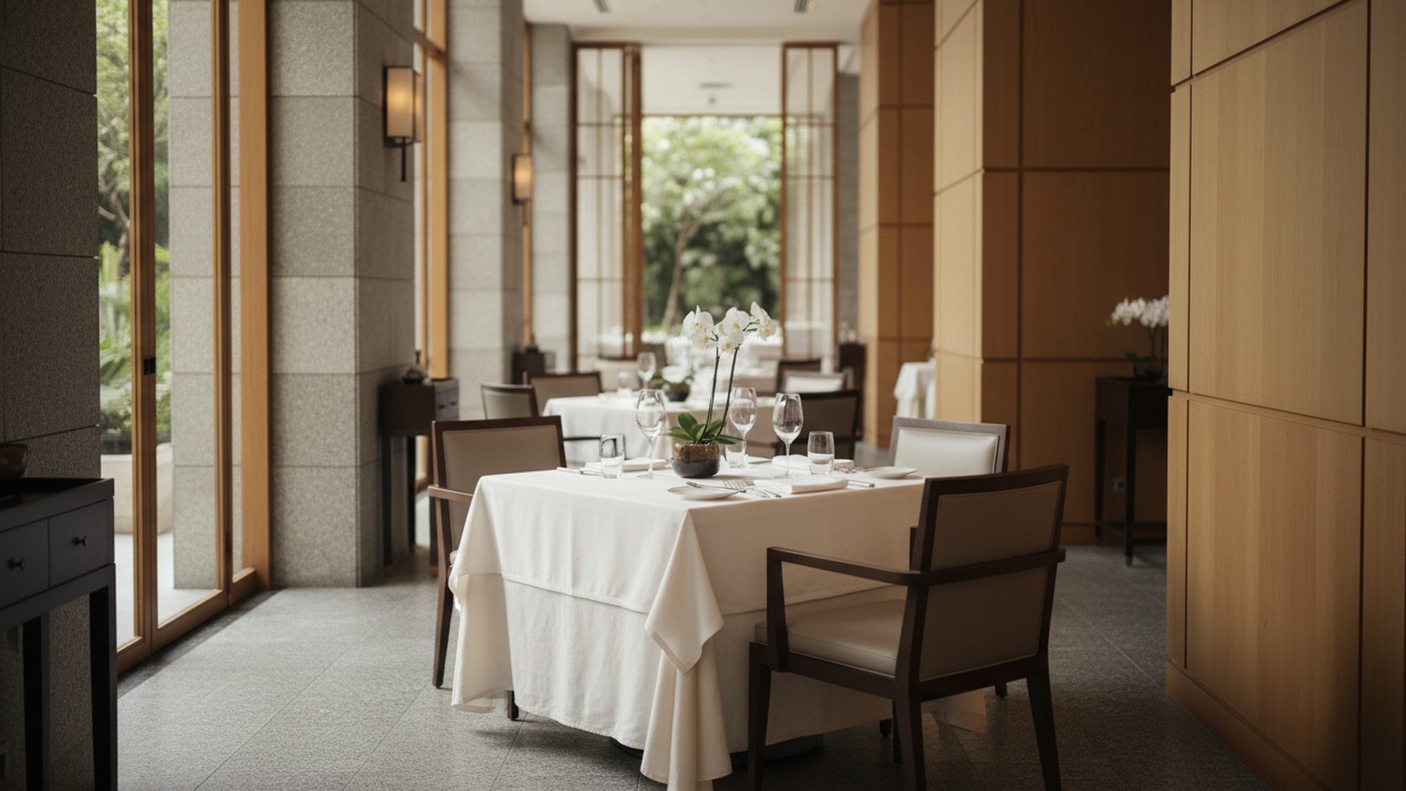Sunlit dining room at Aurelia, tables set for service in soft window light